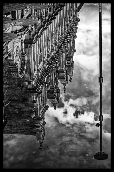 Street facade inverted against cloud
