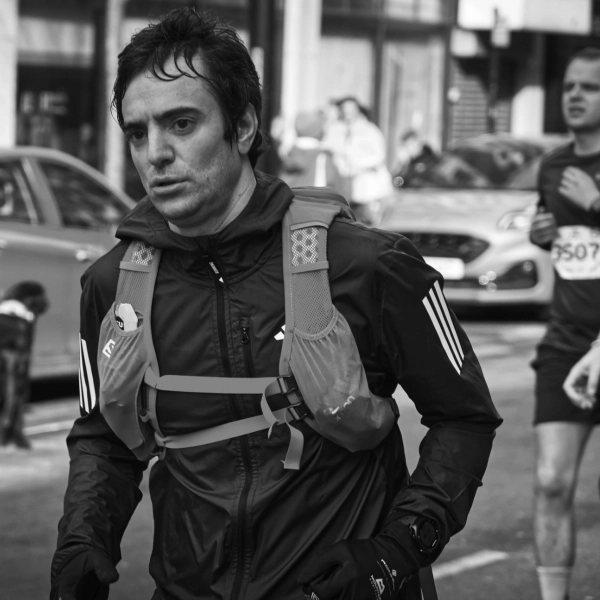 Runner in black, mid-race