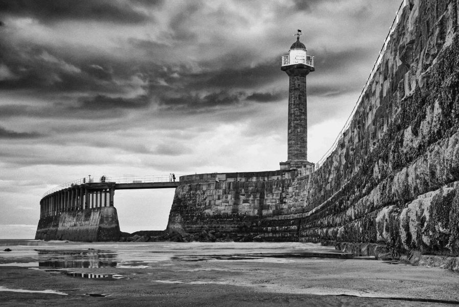 Pier lighthouse under heavy cloud